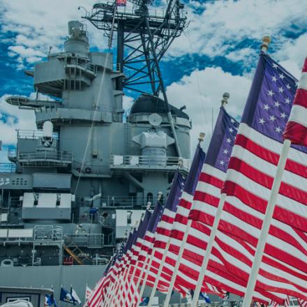 American flags in front of naval vessel